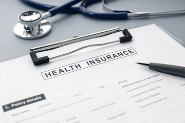 Health Insurance form and stethoscope on desk