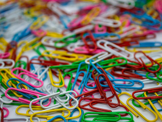 close up selective focus of colorful paperclip as a background and texture with white background in the office