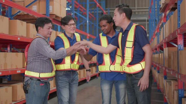 Professional, teamwork and Unity of group warehouse workers in factory storehouse. Colleague, manager and employee standing hands holding together celebrate cheerful success with happy smile.