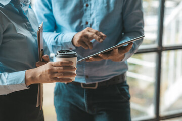 Company meeting room has businessmen and finance managers meeting together on finance topics, they are looking at information on documents and discussing together. Concept company financial management