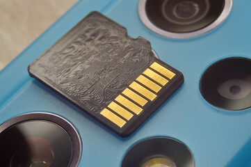 micro sd card lies on the block of smartphone cameras. close-up
