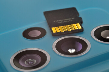 micro sd card lies on the block of smartphone cameras. close-up