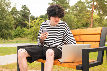 Fototapeta premium a young freelancer works outdoors on his phone