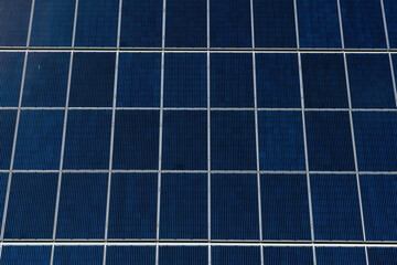 close-up of solar panels. Renewable energy. Environmentally safe sources of electricity. Passing clouds are reflected in the glass surface of the solar panels.