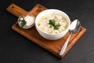 soup with dumplings, soup with sour cream, side view black background
