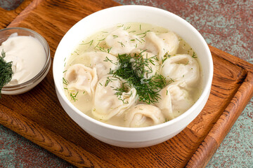 soup with dumplings, soup with sour cream, side view light background
