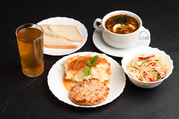three-course lunch, lunch on a dark background side view
