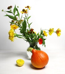 still life with flowers and fruits of orange and yellow colors