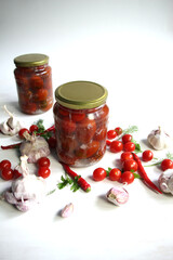 Fototapeta na wymiar tomatoes, garlic and peppers cooked and preserved in glass jars with fresh ingredients on white background