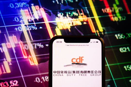 KONSKIE, POLAND - August 10, 2022: Smartphone displaying logo of China Tourism Group Duty Free (CDF) company on stock exchange chart background