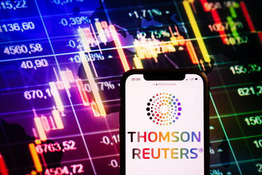 KONSKIE, POLAND - August 10, 2022: Smartphone displaying logo of Thomson Reuters company on stock exchange chart background