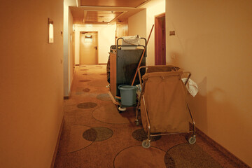 Cleaners trolley with cleaning equipments at hotel