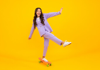 Fototapeta na wymiar Amazed teen girl. Teenagers youth casual culture. Teen girl with skateboard over isolated studio background. Teenager in fashion stylish clothes. Excited expression, cheerful and glad.