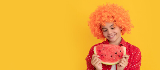 smiling teen girl in fancy orange hair wig hold fresh ripe watermelon fruit slice, joy. Summer girl portrait with watermelon, horizontal poster. Banner header with copy space.