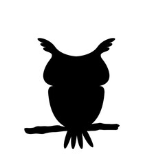 A haunted owl silhouette perched on a branch on a Halloween night.