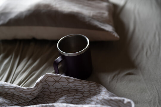 Insulated Coffee Mug In Messy Bed