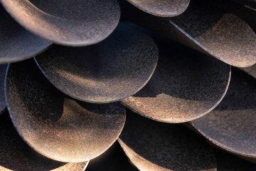 Abstract close up of rusty cold rolled steel bent into scallop shapes, nobody