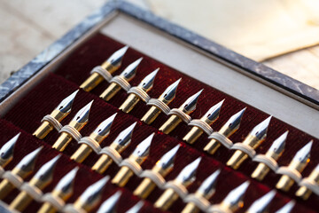 Penmanship. Vintage unused high grade dip pen (or nib pen) pen nibs in a case. Shallow depth of...