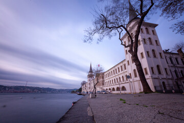 The military high school with a tower, photographed with the long exposure technique, is an...