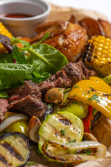 meat with vegetables and sauces on a wooden desk .pork , lamb, chicken meat . Meat set