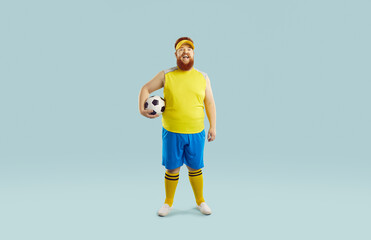 Full body studio shot of funny fat football player. Happy overweight bearded guy in yellow top and...