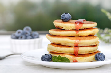 American pancakes with berries and jam. Sweet tasty breakfast, dessert.