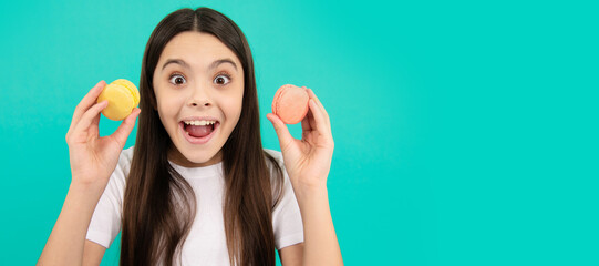 amazed kid hold french macaron or macaroon cookies, amazement. Teenager child with sweets, poster banner header, copy space.