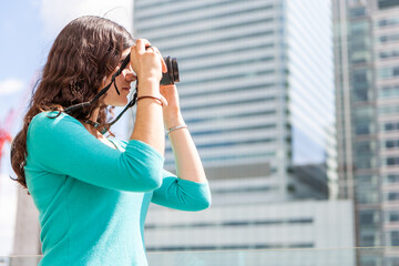 Teenage Students, photographer. A college student working on her photographic skills in an urban...