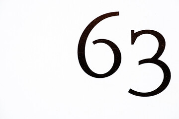 house number 63 painted at the  wall