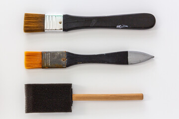 Set of paint brushes made from synthetics hairs and sponge on white background.
