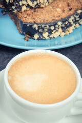 Fresh pastry made of zucchini on blue plate and cup of white coffee. Delicious dessert
