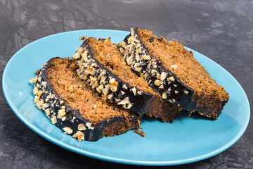 Pieces of zucchini dough with nuts and raisins on blue plate
