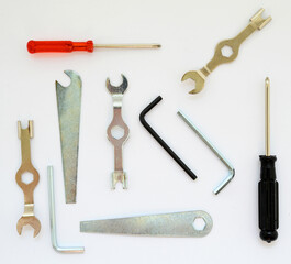 set of locksmith tools, hex keys, box wrenches, wrenches and screwdrivers close-up on a white background
