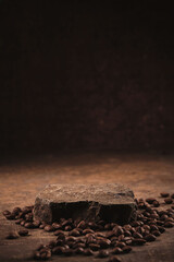 Roasted coffee beans on stone pedestal brown background