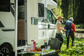 Camping Couple Next to Their Class C Motor Home