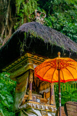 Tendung: Balinese temple umbrella in front a offering temple.