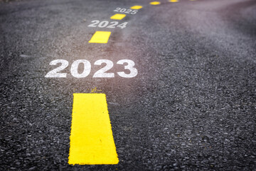 New year 2023 to 2025 on asphalt road with marking lines. Business startup challenge concept and...