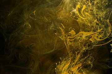 Liquid fluid art abstract background. Black, yellow dancing acrylic paints underwater, space smoke...