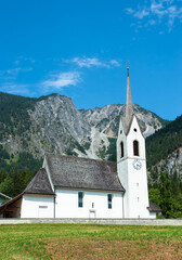 Fototapeta na wymiar Sankt Anton im Montafon, Austria - July 25, 2022: A church of Holy Antony in Montafon, Vorarlberg, Austria