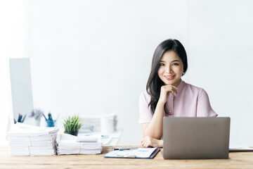 Asian woman working with laptop in her office. business financial concept.