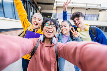 Group of multiracial students taking selfie picture at school - Happy young people hanging outside together - Teenagers in college campus - Back to school concept