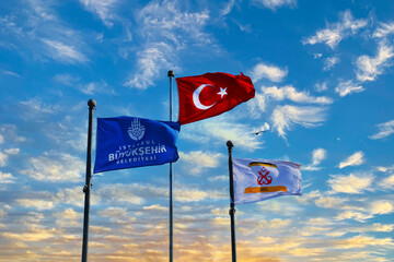 The flag of the Istanbul metropolitan municipality and the maritime flag waving together with the Turkish flag on the pier in Istanbul Eminonu, three side by side