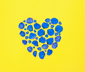Ukrainian flag in heart shape made from flower petals.