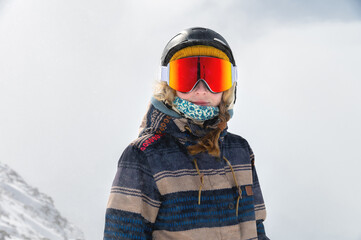 Fototapeta na wymiar Macro portrait. Young adult woman, snowboarder or skier in a snowy winter on a mountain slope