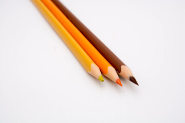 Group of colored pencils and crayons on white background. Text space.