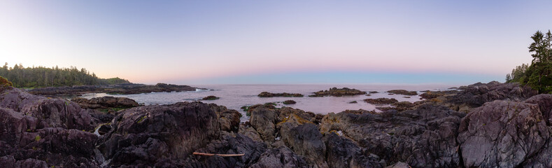 Fototapeta na wymiar Rocky Coastline on the West Coast of Pacific Ocean. Twilight Sunrise Sky. Ucluelet, Vancouver Island, British Columbia, Canada. Nature Background Panorama