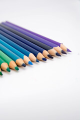 Group of colored pencils and crayons on white background. Text space.