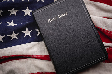 Christian Holy Bible placed on a vintage American flag