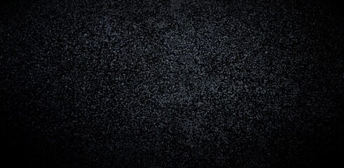 Asphalt black low textured background. Dark sanded surface.