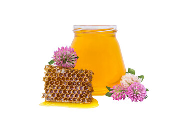 isolate jar with honey and piece of beeswax and clover flower